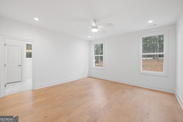 spare room featuring ceiling fan and light wood-type flooring