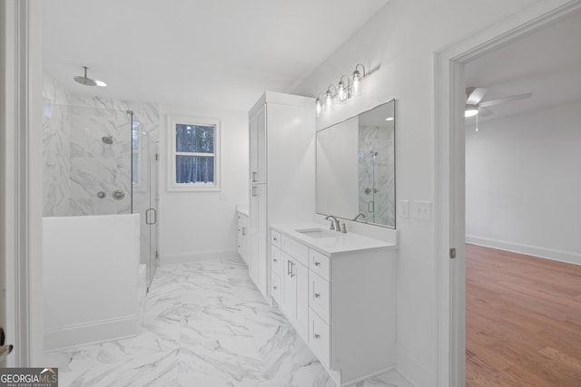 bathroom with vanity, a shower with shower door, and ceiling fan