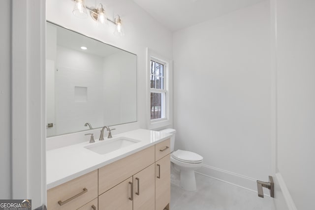 bathroom featuring walk in shower, vanity, toilet, and tile patterned flooring