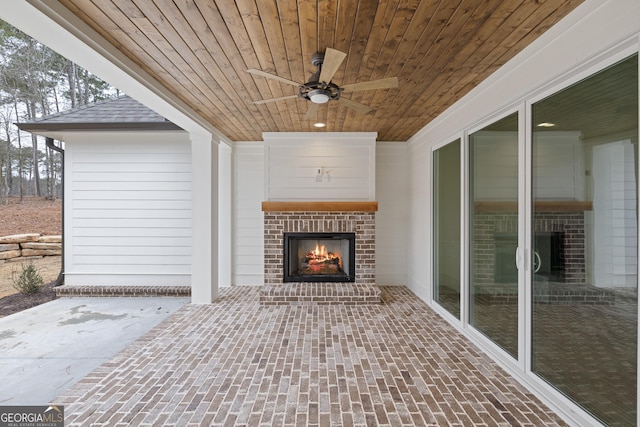 view of patio / terrace featuring an outdoor brick fireplace