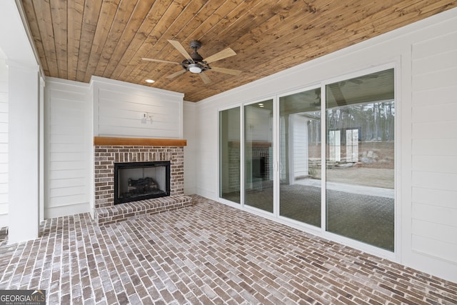 view of patio / terrace with ceiling fan and a fireplace