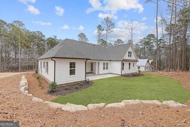 back of property featuring a yard and a patio area