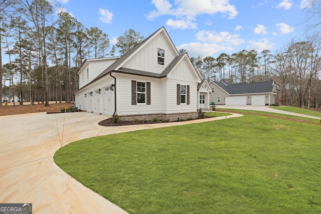 modern farmhouse featuring a garage and a front lawn