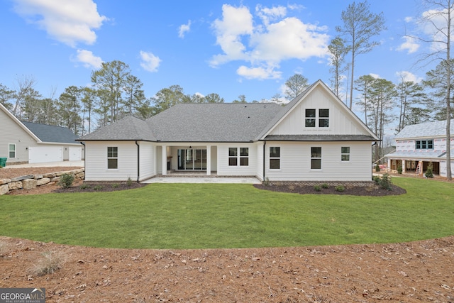 rear view of property with a yard and a patio area