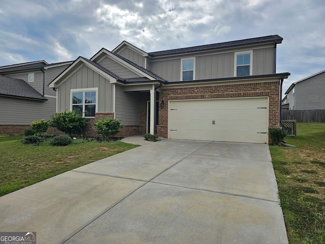 view of front of home with a front lawn and a garage