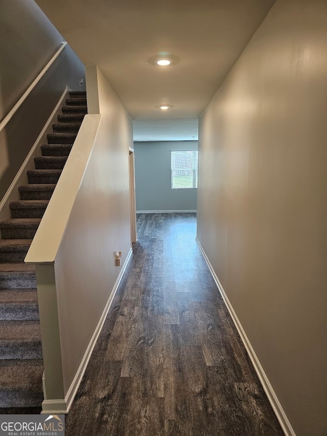 hallway with dark hardwood / wood-style flooring