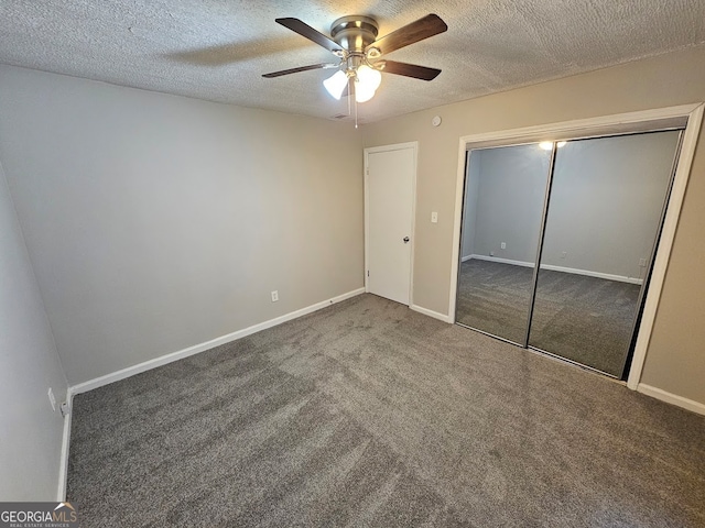 unfurnished bedroom with a closet, ceiling fan, carpet flooring, and a textured ceiling