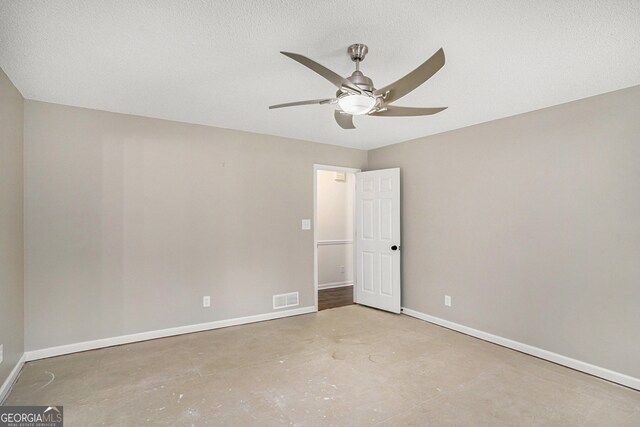 unfurnished room featuring ceiling fan, a textured ceiling, and concrete flooring