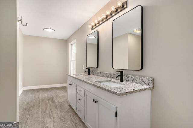 bathroom with vanity and hardwood / wood-style flooring