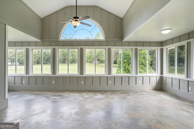 unfurnished sunroom with ceiling fan and vaulted ceiling