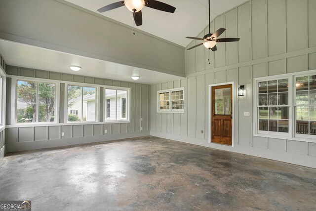 unfurnished sunroom with ceiling fan