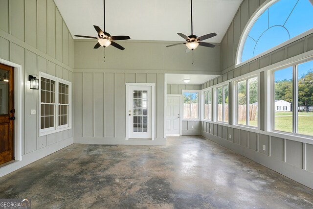 unfurnished sunroom with ceiling fan