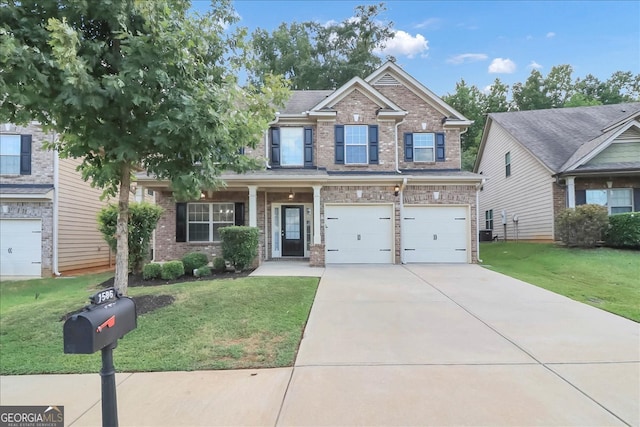 craftsman house featuring a garage and a front yard