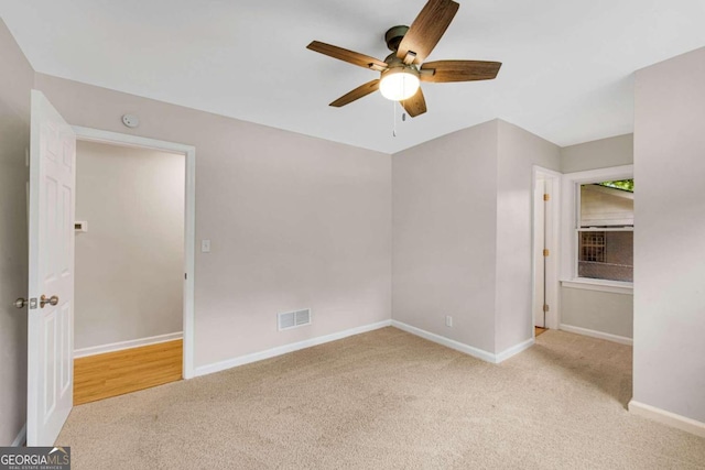 unfurnished bedroom with light colored carpet and ceiling fan