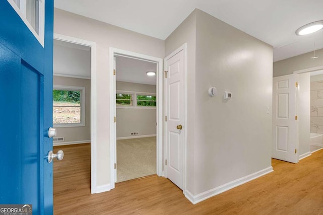 corridor with light hardwood / wood-style flooring