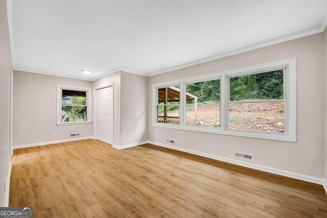 unfurnished room featuring light hardwood / wood-style flooring and a wealth of natural light