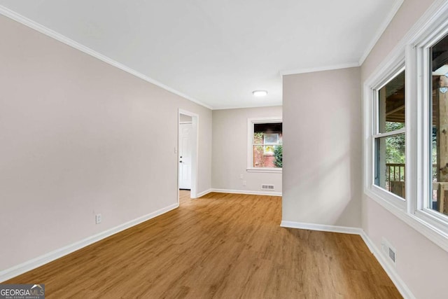 unfurnished room featuring light hardwood / wood-style floors and ornamental molding