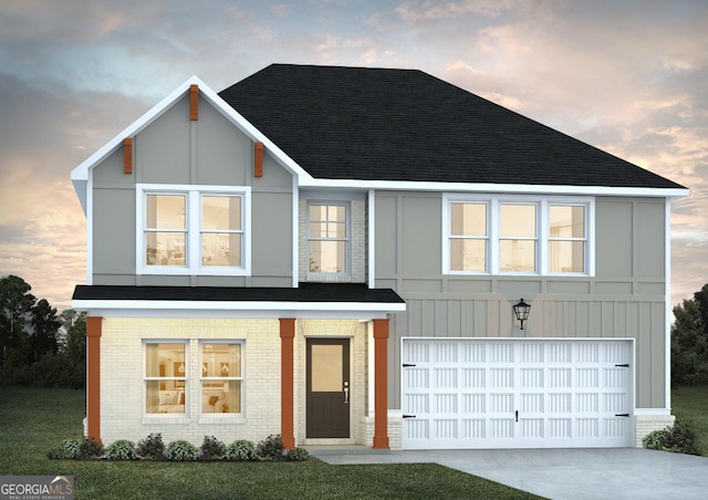 view of front of property with a lawn and a garage