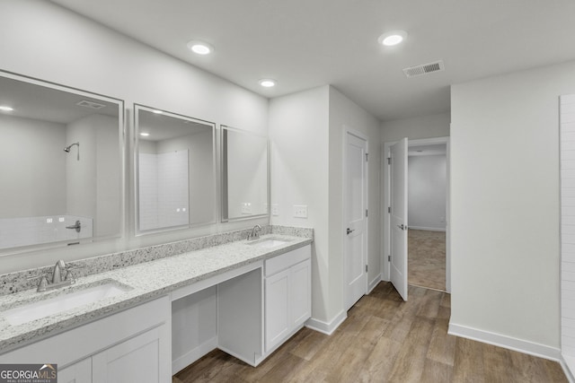 bathroom with hardwood / wood-style flooring and vanity