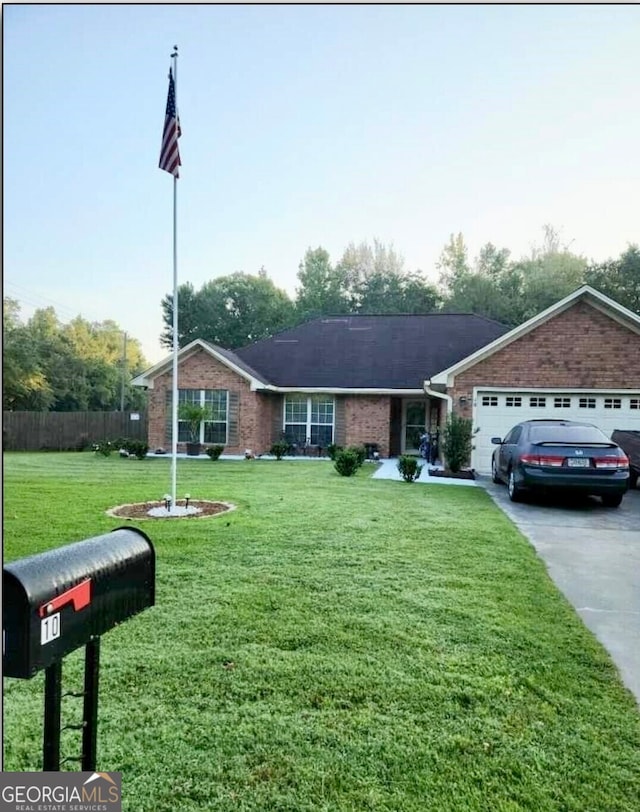 view of front of house featuring a front lawn and a garage