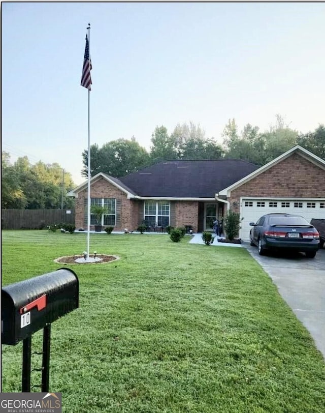 view of front facade with a front yard and a garage