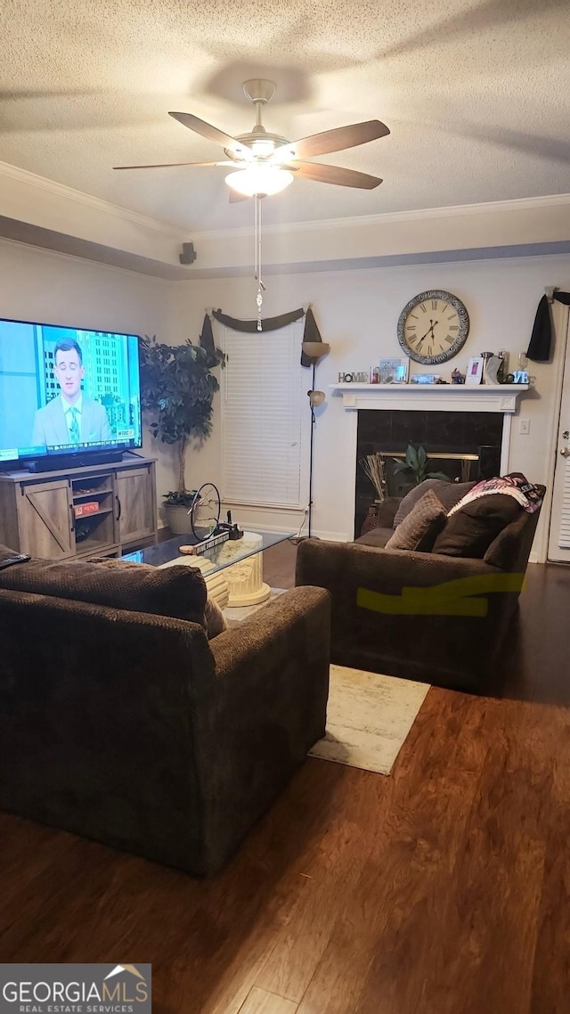 living room with ceiling fan, a textured ceiling, and hardwood / wood-style floors