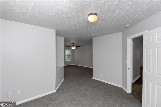 carpeted empty room with a textured ceiling and ceiling fan