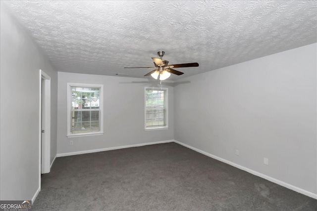 carpeted spare room with ceiling fan and a textured ceiling