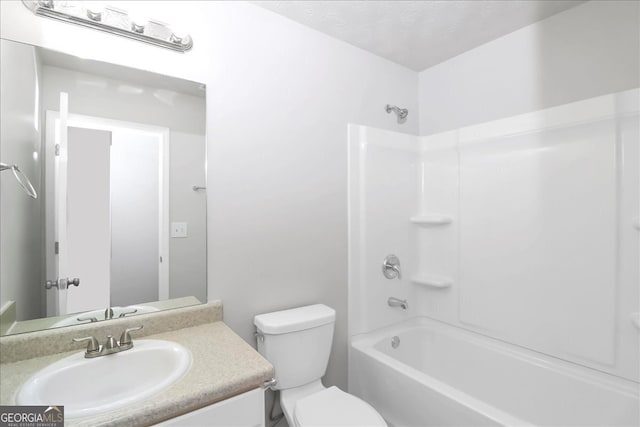 full bathroom with a textured ceiling, shower / bathtub combination, vanity, and toilet