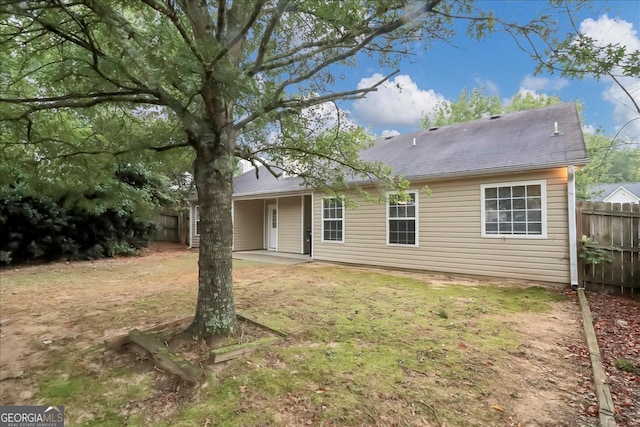 back of house featuring a patio area and a yard