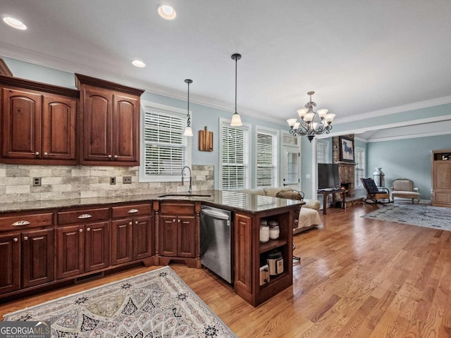 kitchen featuring an inviting chandelier, light hardwood / wood-style flooring, crown molding, decorative light fixtures, and appliances with stainless steel finishes