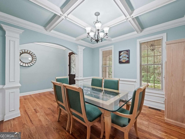 dining area with coffered ceiling, ornamental molding, beam ceiling, dark hardwood / wood-style flooring, and a chandelier