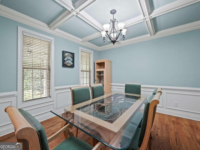 dining room with decorative columns, hardwood / wood-style flooring, coffered ceiling, and a notable chandelier