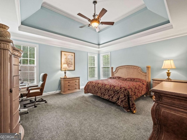 bedroom with carpet flooring, ceiling fan, crown molding, and a tray ceiling