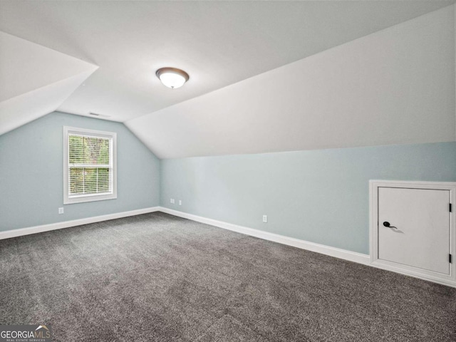 bonus room featuring carpet and vaulted ceiling