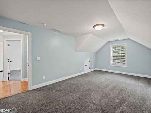 additional living space featuring carpet and lofted ceiling