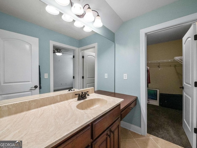 bathroom featuring ceiling fan, tile patterned flooring, vaulted ceiling, toilet, and vanity