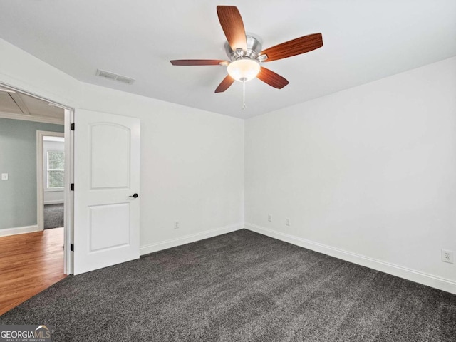 unfurnished bedroom featuring ceiling fan and dark colored carpet