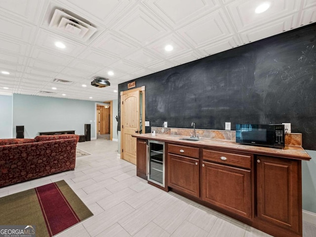 kitchen with wood walls, dark brown cabinetry, stainless steel fridge with ice dispenser, and light tile patterned floors