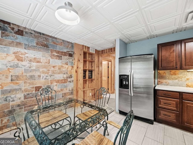 kitchen featuring wood walls, sink, and beverage cooler