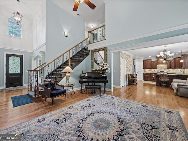 interior space featuring a towering ceiling and hardwood / wood-style flooring