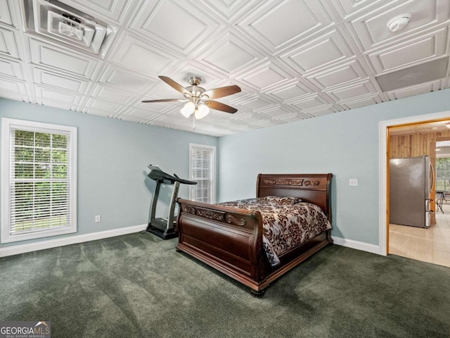 bedroom featuring ceiling fan and dark carpet