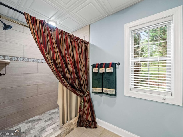 laundry room with washer and dryer, light tile patterned flooring, and cabinets