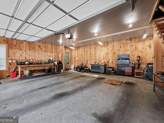 garage with a garage door opener and wooden walls