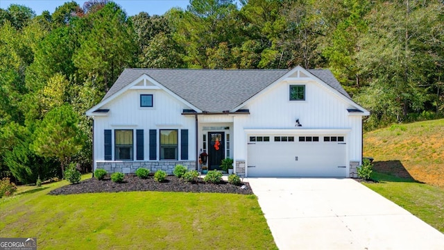 modern farmhouse style home featuring a front yard and a garage