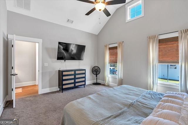 bedroom with light carpet, multiple windows, and ceiling fan