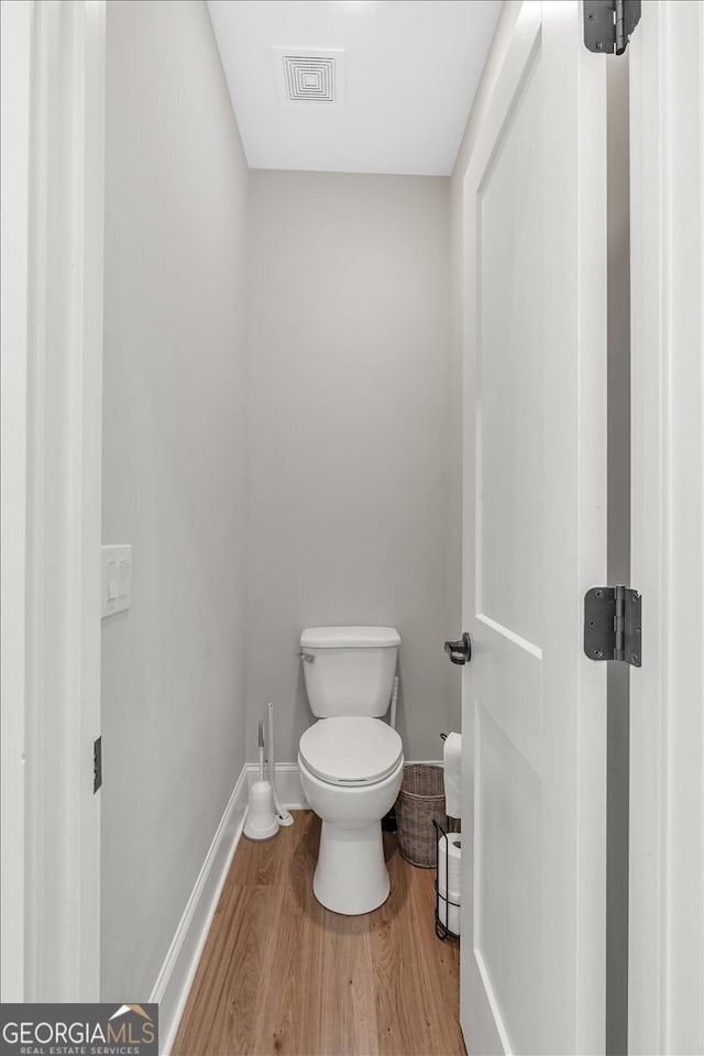 bathroom featuring hardwood / wood-style floors and toilet