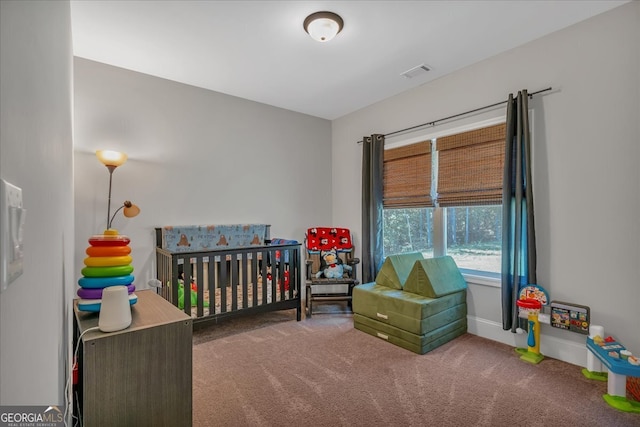 carpeted bedroom with a crib