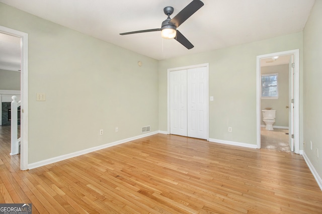 unfurnished bedroom with connected bathroom, ceiling fan, light hardwood / wood-style flooring, and a closet