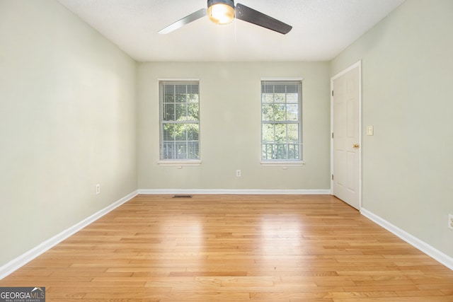 unfurnished room featuring light wood-type flooring and ceiling fan